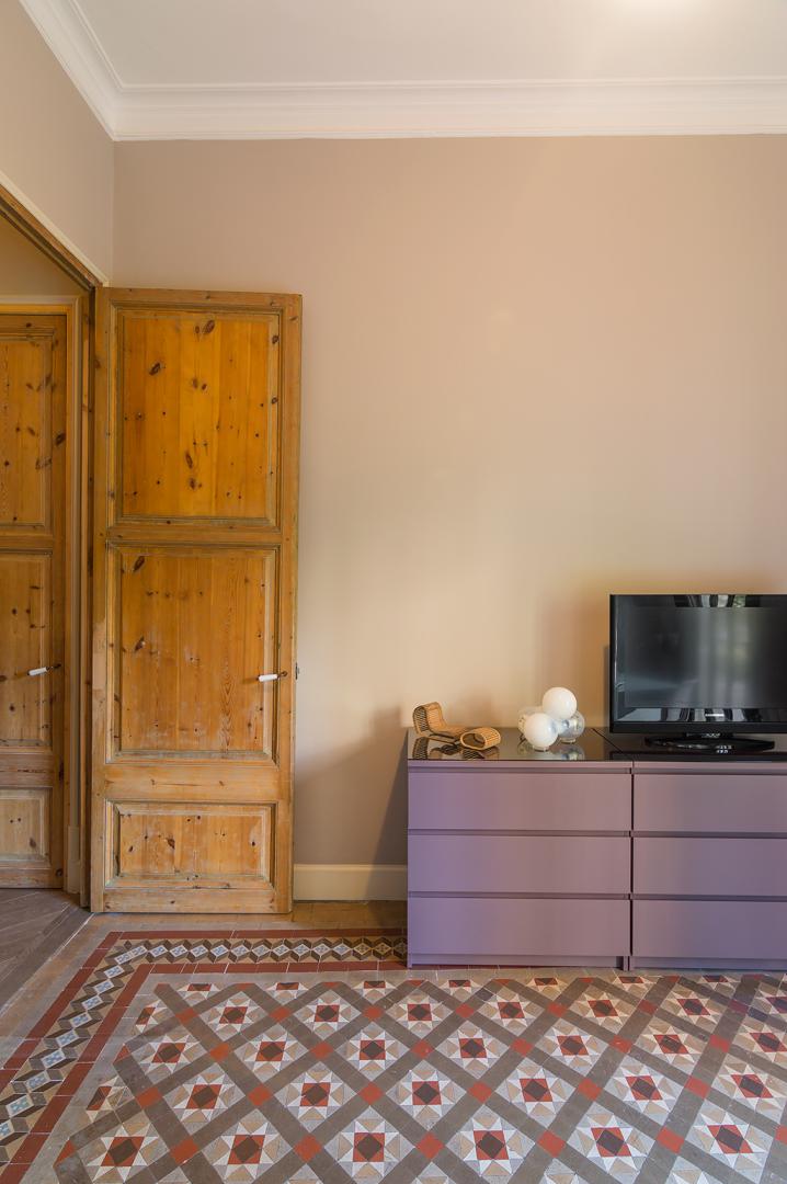 living room with piano armchairs and bookcase