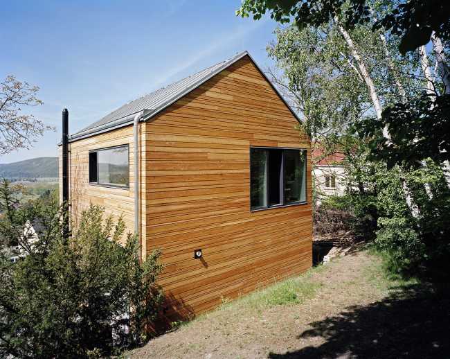 Summer villa outside Prague. Larch cladding for a solidly shaped wooden house