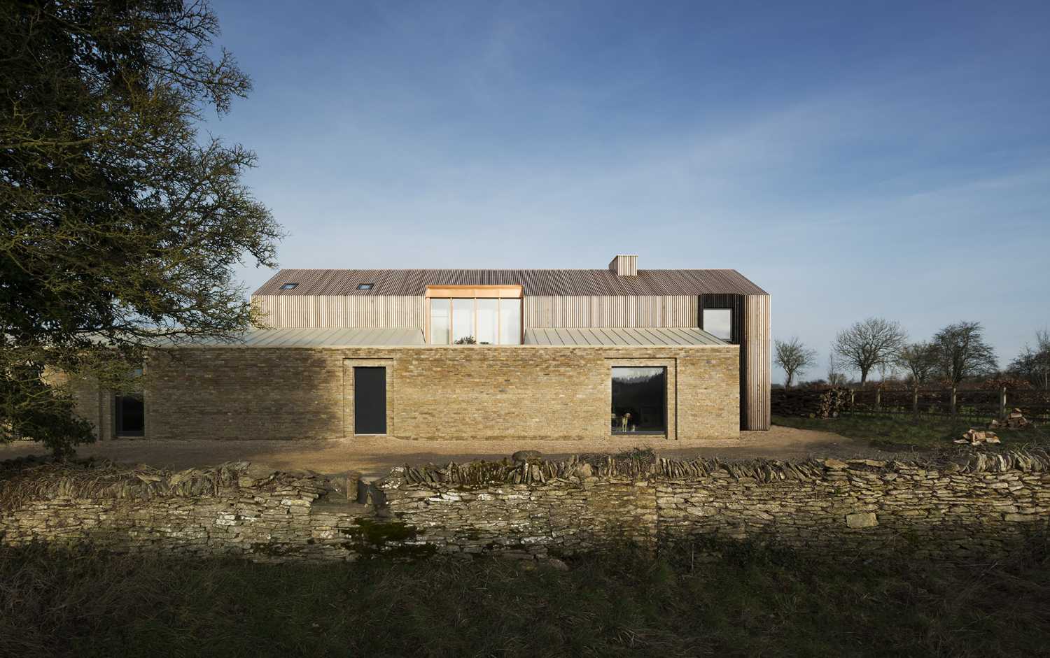 Pattern of traditional volumes in a barn. Shapes and palette of local materials