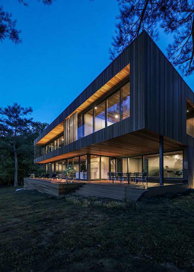 Housing on the shores of a lake. Horizontal structure in a picturesque natural landscape