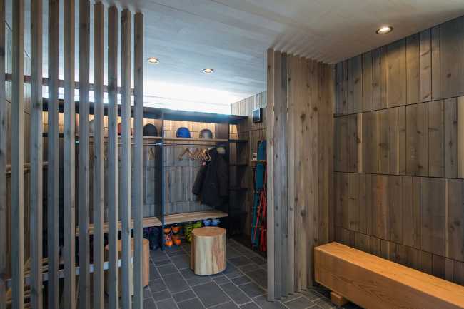 Architectural dialogue between cedar and metal for the Hiyoku house, set against the backdrop of the snow-capped mountains of Japan.