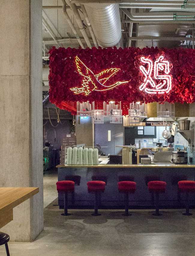 Ho Lee Chix. Red flowers and crane-shaped neon for a street food stall