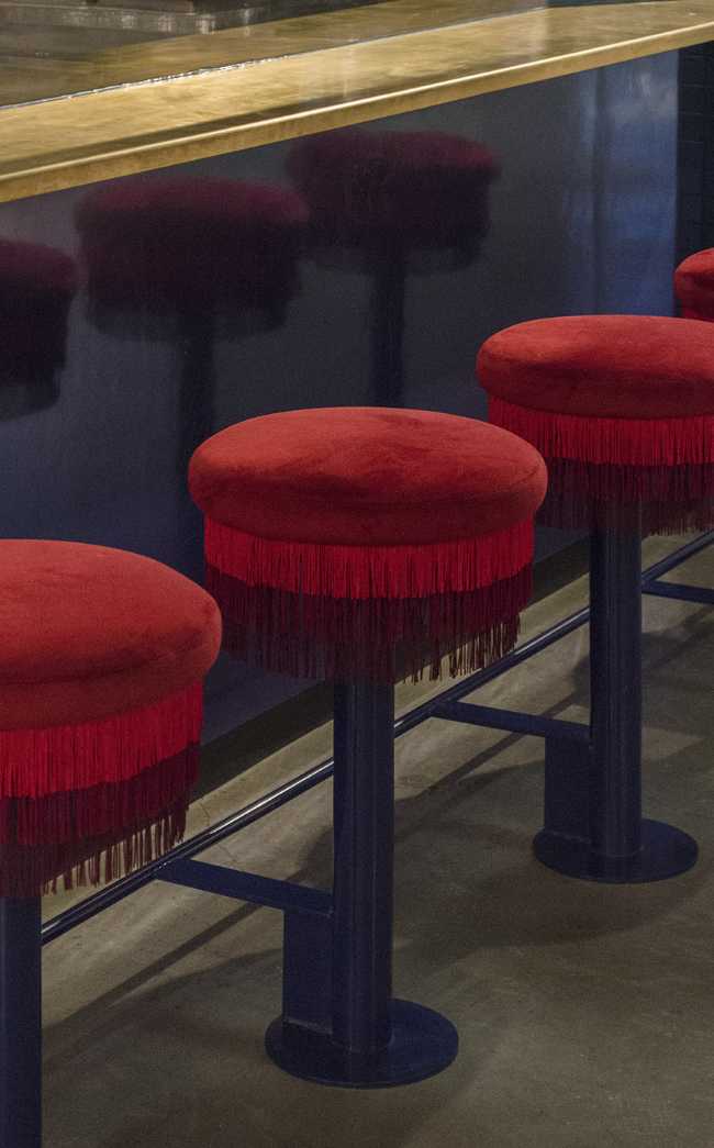 Ho Lee Chix. Red flowers and crane-shaped neon for a street food stall