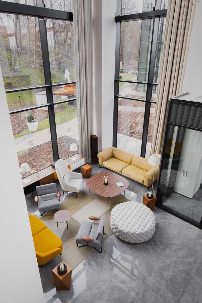 Huge wooden books create the space for the Lobby of the Philosophers Residence in Latvia