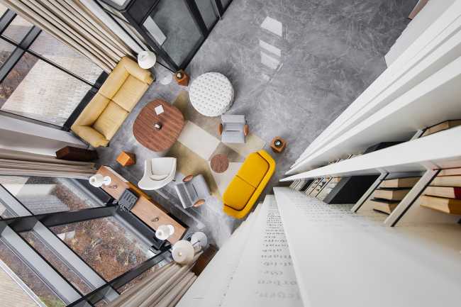 Huge wooden books create the space for the Lobby of the Philosophers Residence in Latvia