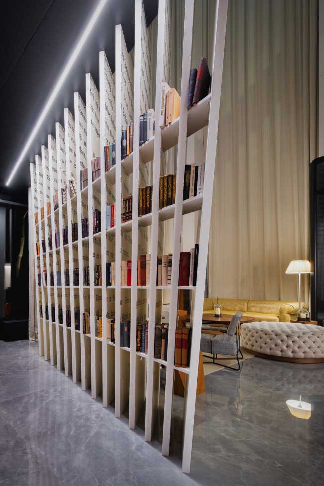 Huge wooden books create the space for the Lobby of the Philosophers Residence in Latvia