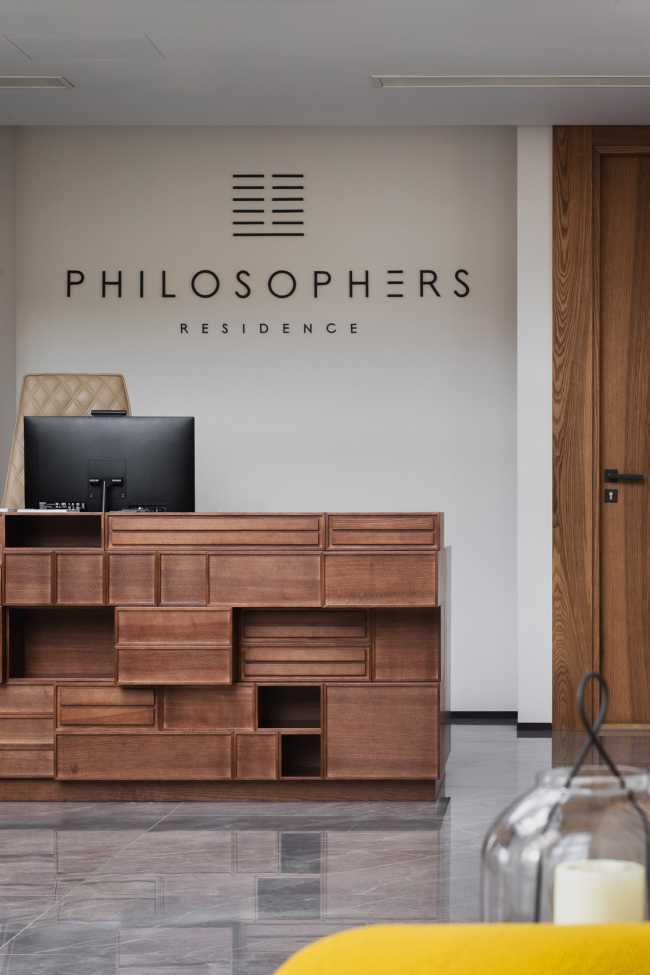 Huge wooden books create the space for the Lobby of the Philosophers Residence in Latvia