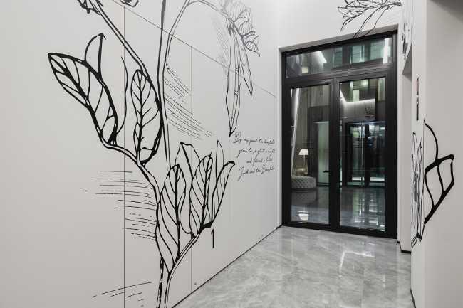 Huge wooden books create the space for the Lobby of the Philosophers Residence in Latvia