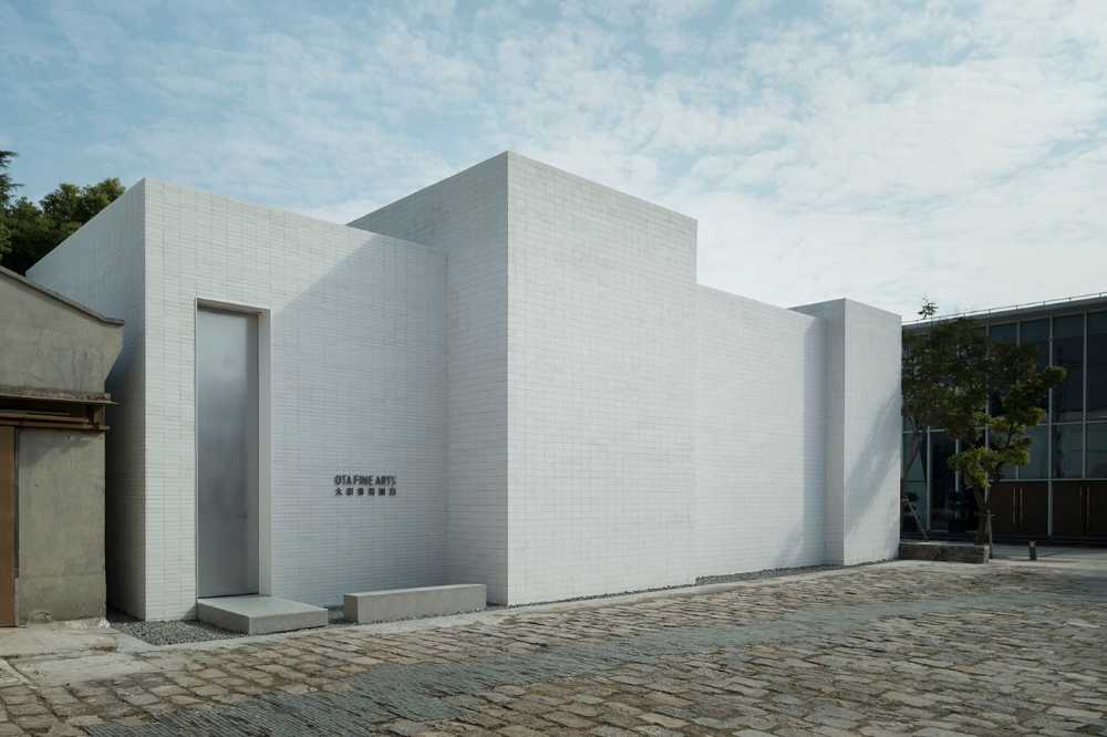 Purity of volume, natural light and traditional materials blend in the design of the new OTA FINE ARTS gallery