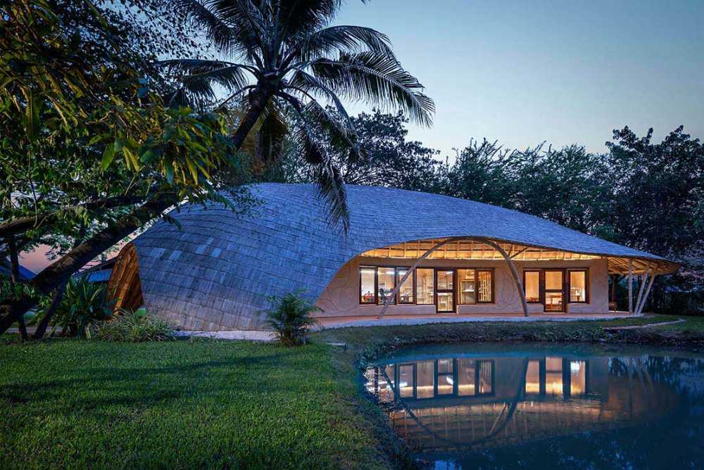Architecture studio on water's edge. Organic temple of creativity