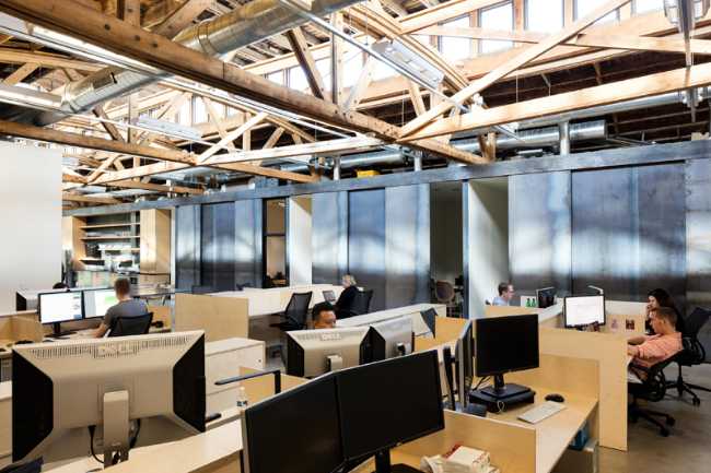 open space brick with wooden roof desks
