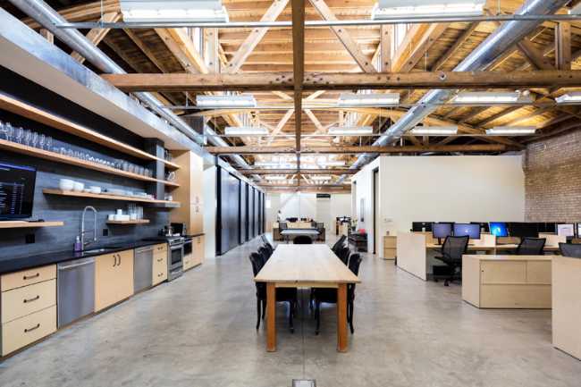 open space offices in brick and kitchen and wooden tables