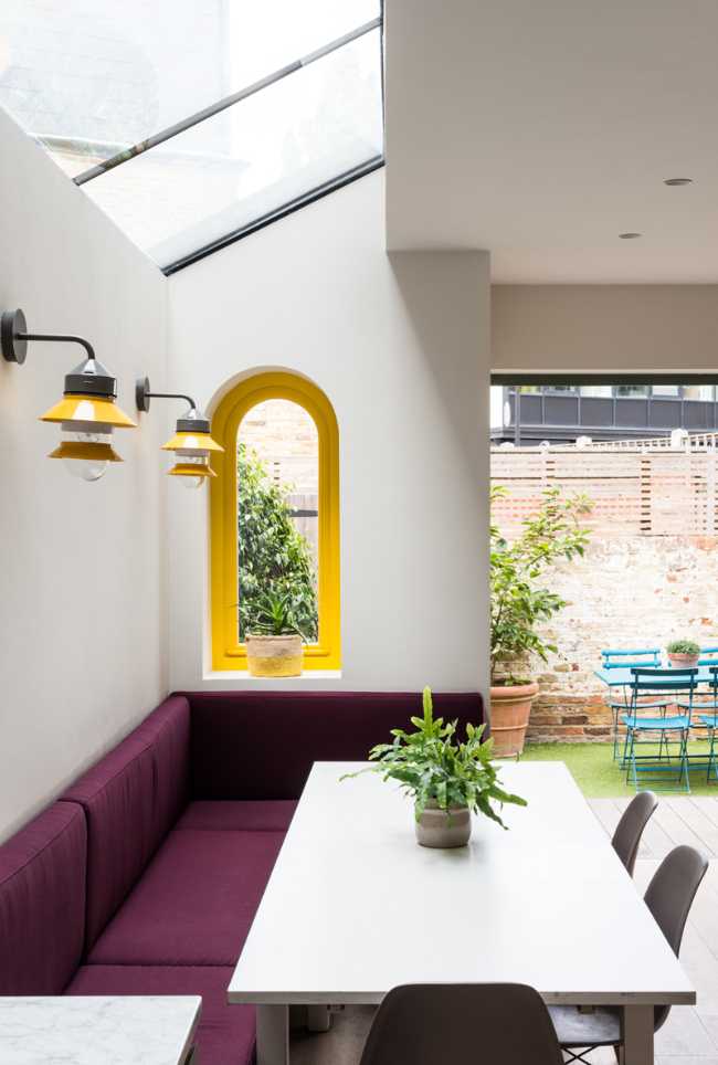 Windows with a yellow window frame on the dining area