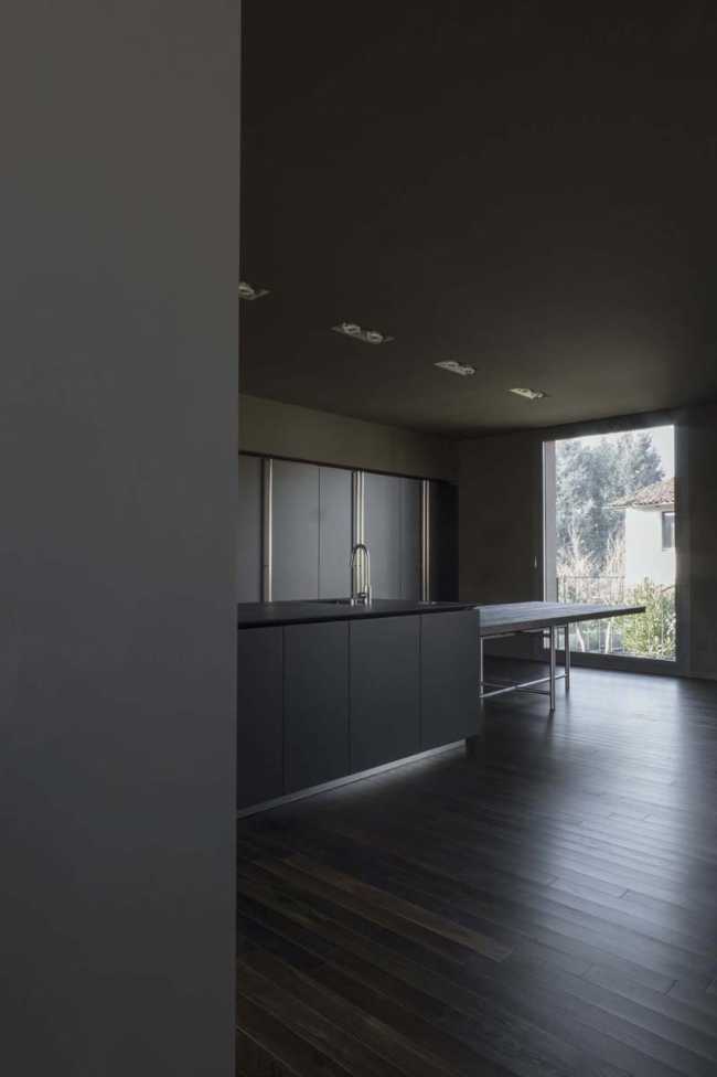 The minimalist kitchen with the wooden floor