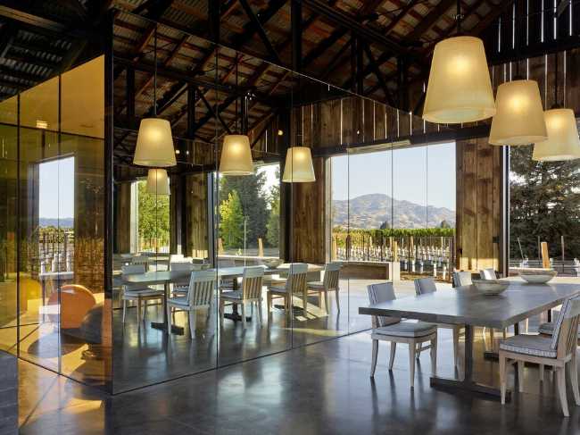 Wooden furnishings, a large window and cement floor for the interior of the room