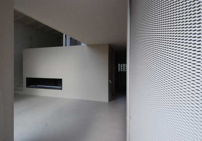The custom-made fireplace is minimalist in light tones