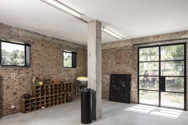 Concrete floor and exposed red brick walls