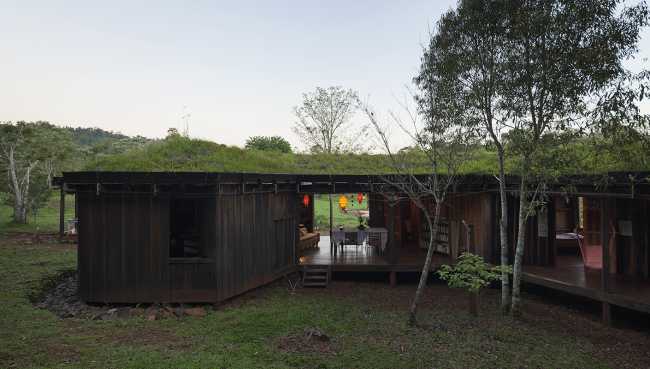 Wooden hostel with green roof