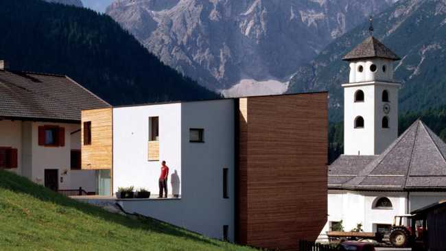 White and wooden house with panoramic background