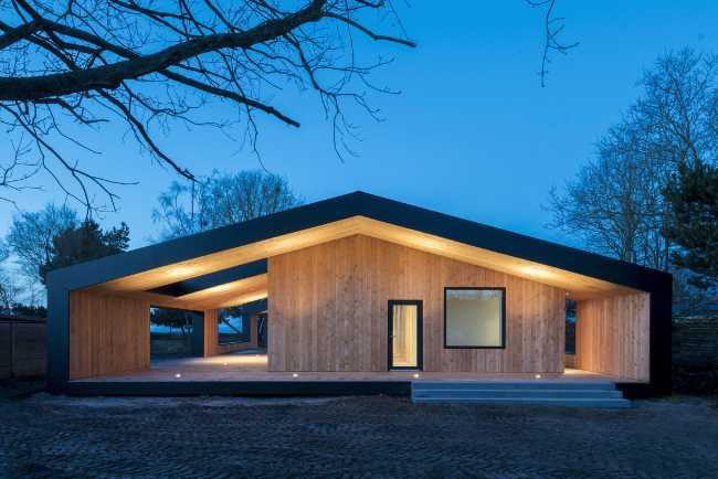 Wooden house illuminated at night