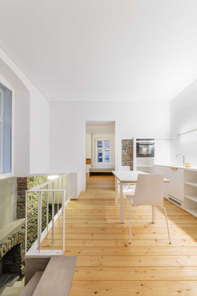 White interior with parquet and metal balustrade