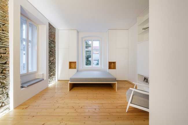White interior and stone with parquet and metal balustrade