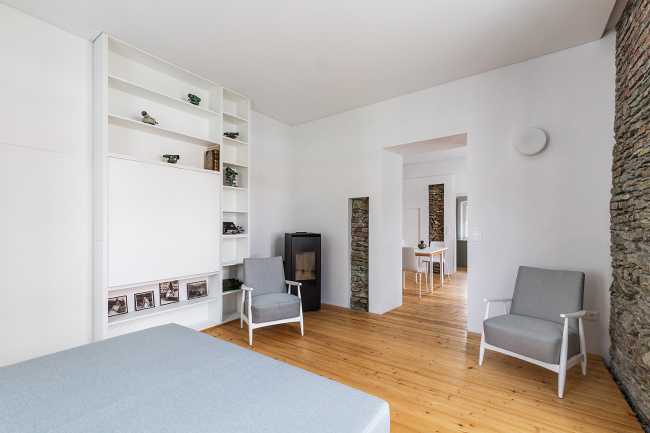 White bedroom with parquet flooring