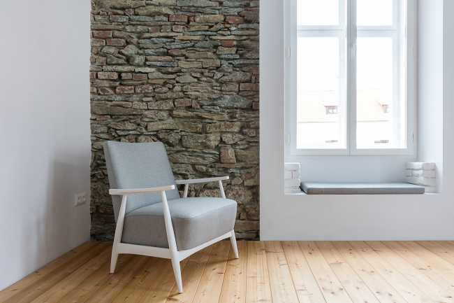 Corner with stone wall and armchair