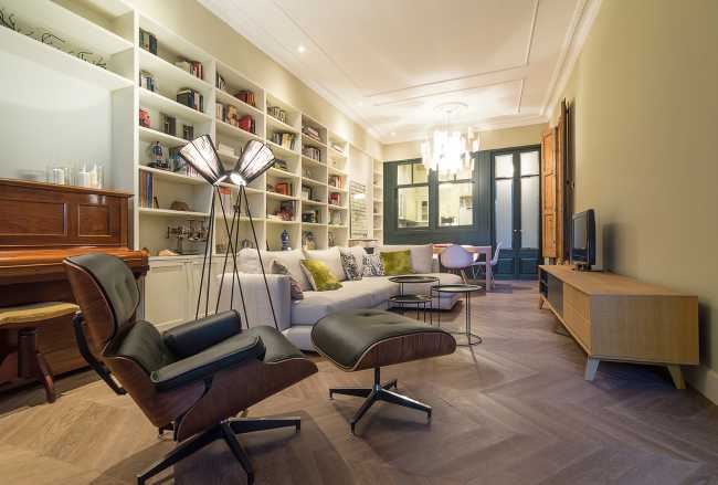 living room with sofa chairs and wall bookcase