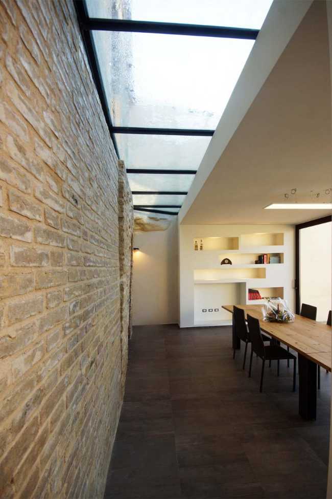 Interior of a house with a stone wall and a skylight