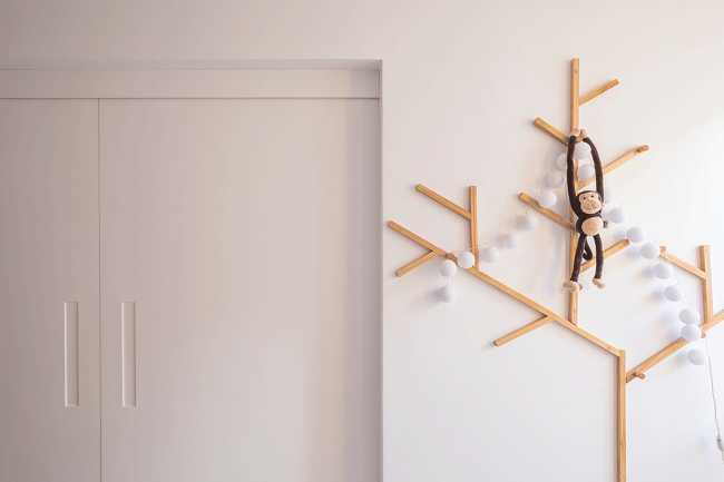 Coat hanger in wood and white wall