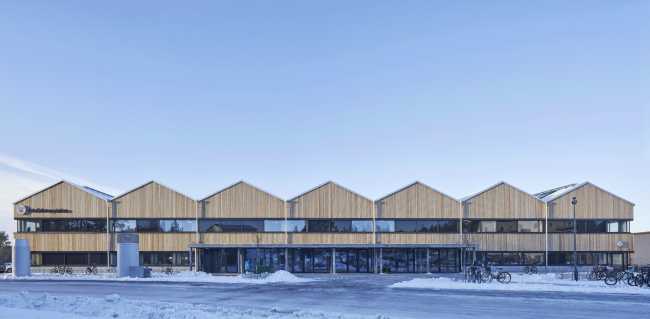 Wooden school with industrial roof