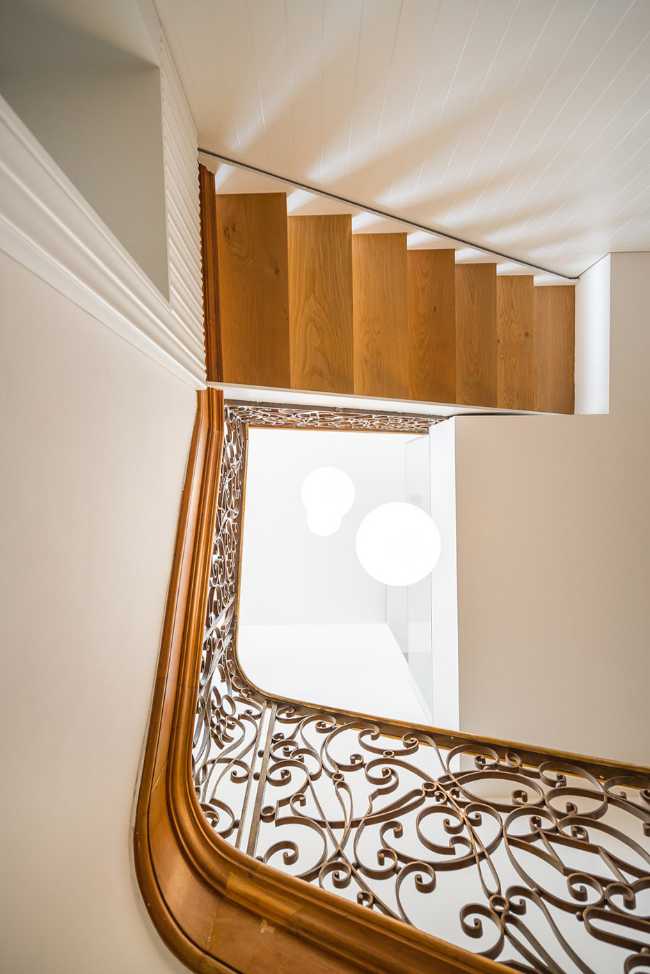 Wooden staircase with cast iron balustrade