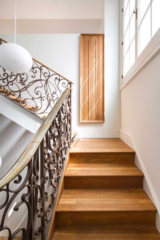 Wooden staircase with cast iron balustrade