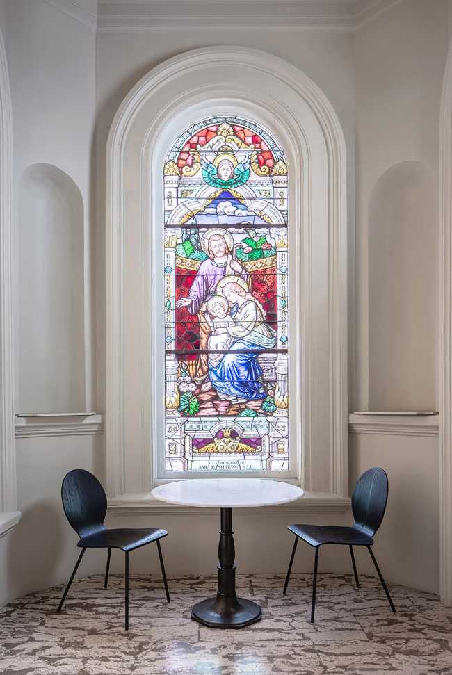 Stained glass window of a church and small table