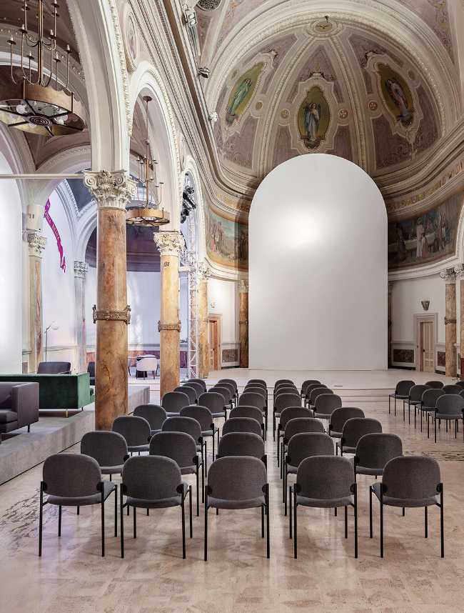 Seated in a nave of a church
