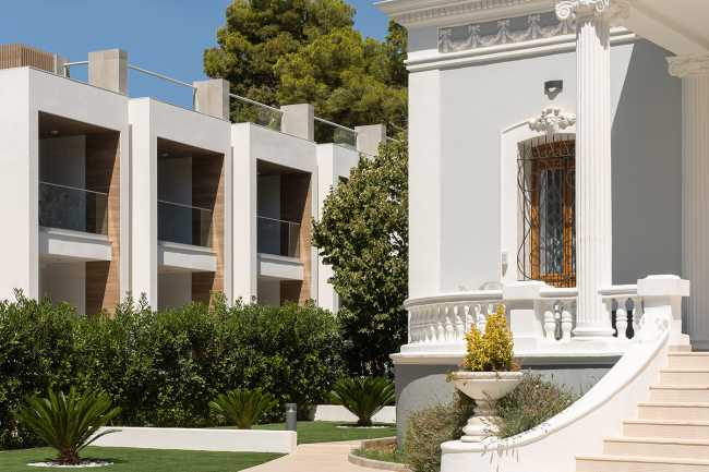 historic villa and hotel complex facing wood facade