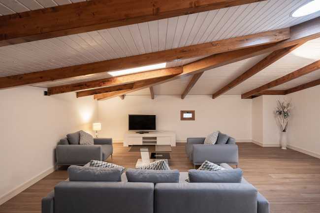 attic lounge with exposed beams