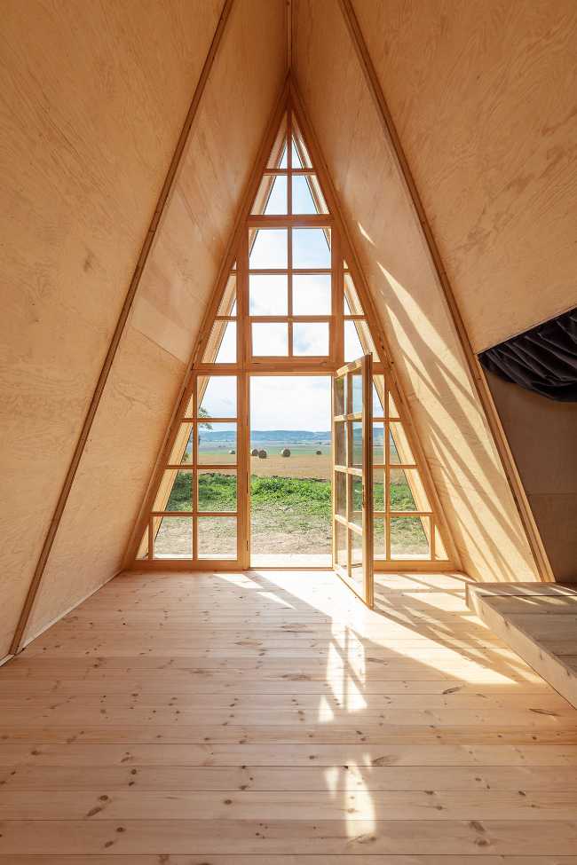 Wooden cabin with triangular shape