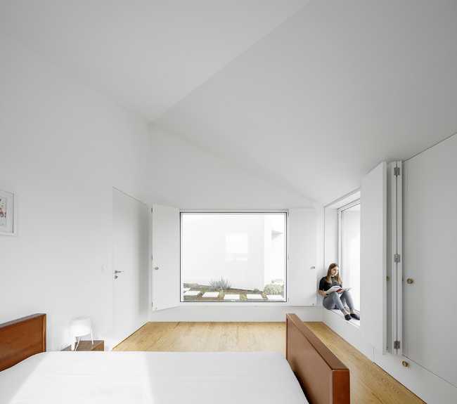 Old renovated farmhouse. Three white volumes stand on a rustic ground floor
