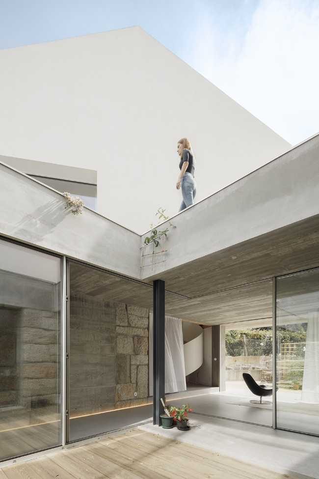 Old renovated farmhouse. Three white volumes stand on a rustic ground floor