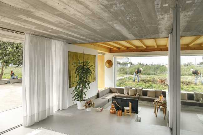 Old renovated farmhouse. Three white volumes stand on a rustic ground floor