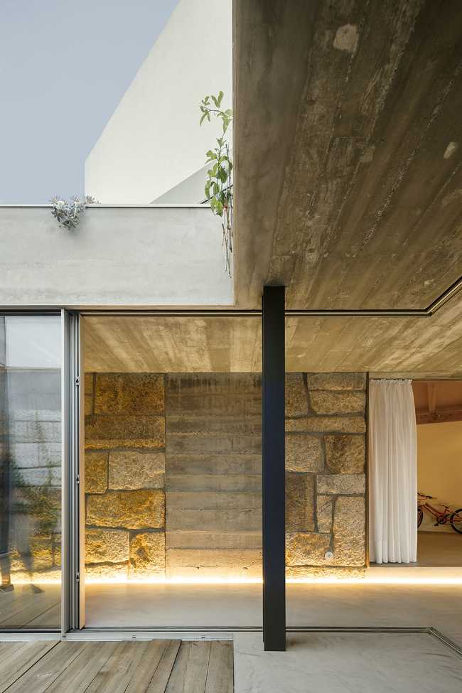 Old renovated farmhouse. Three white volumes stand on a rustic ground floor