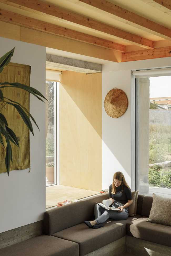 Old renovated farmhouse. Three white volumes stand on a rustic ground floor