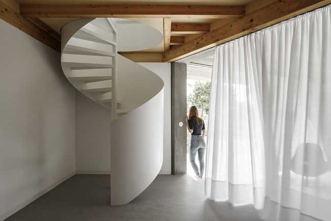 Old renovated farmhouse. Three white volumes stand on a rustic ground floor