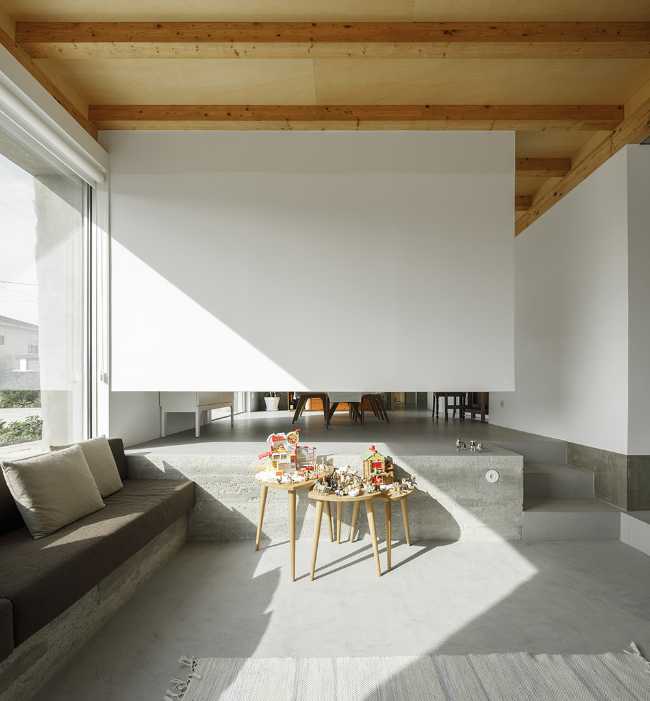 Old renovated farmhouse. Three white volumes stand on a rustic ground floor